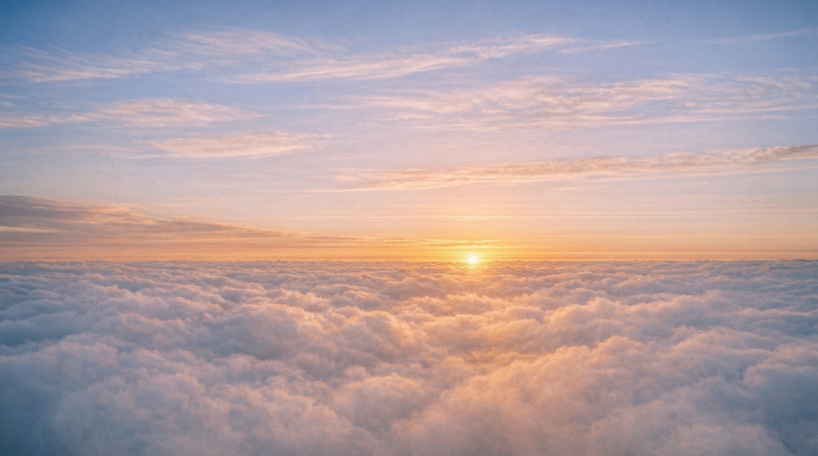 Unified atmospheric system at dawn where thermal currents and cloud formations operate as one coherent phenomenon - both layers visible, both aligned.